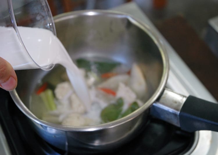 Coconut chicken soup cooking on the stove top