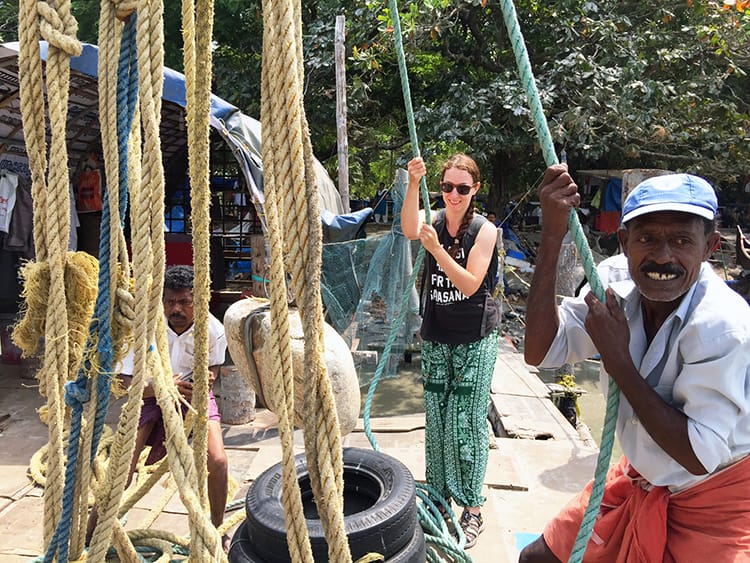 Michelle Della Giovanna from Full Time Explorer and the fishermen smile as they sing and pull the net out of the water