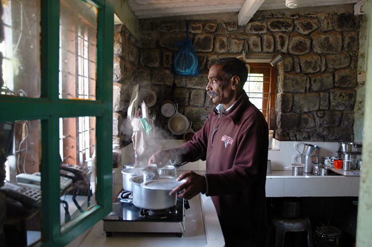 A man makes fresh tea in a tea plantation in Munnar, India