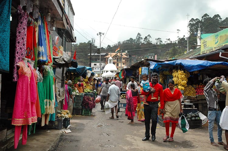 People walk through the shops in the Munnar city center