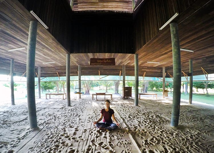 Michelle Della Giovanna from Full Time Explorer sits cross legged ready to meditate at a 10 Day Vipassana in Thailand