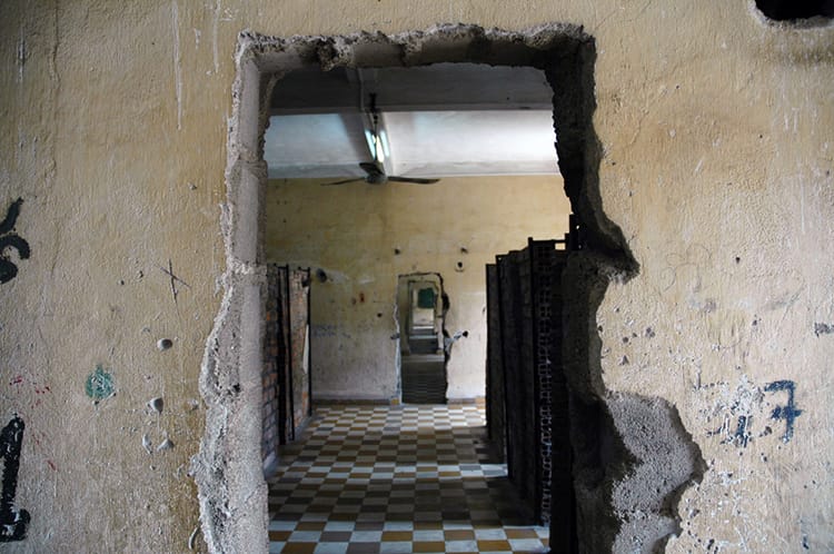 A creepy hallway in the desolate prisoner cells of S21 Prison in Phnom Penh, Cambodia
