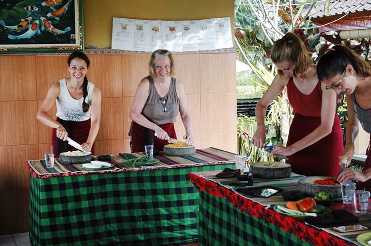 Michelle Della Giovanna from Full Time Explorer and her mom chop ingredients for the Balinese cooking class in Ubud