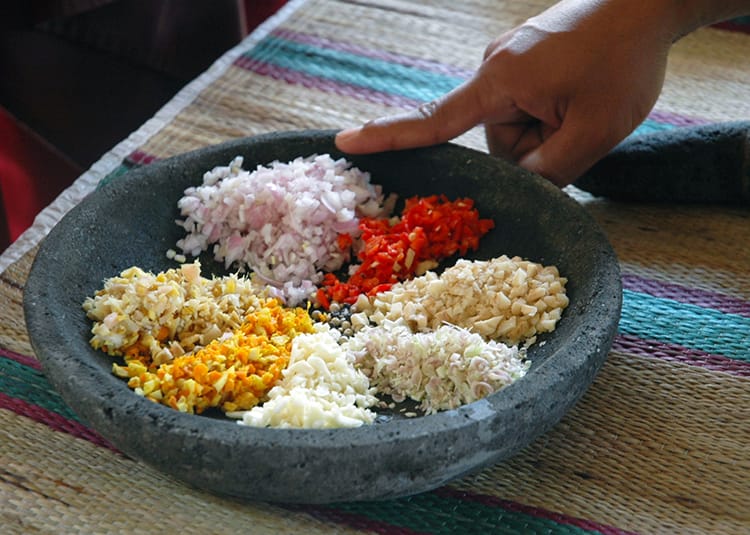 The ingredients for the basic sauce sit in a large stone bowl