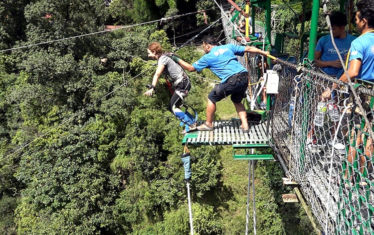 Michelle Della Giovanna from Full Time Explorer prepares to bungy jump in Nepal as she stands at the edge of the platform