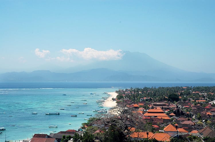 The view from Panorama Point on Nusa Lembongan which overlooks the orange roofs below and the volcano on neighboring Bali