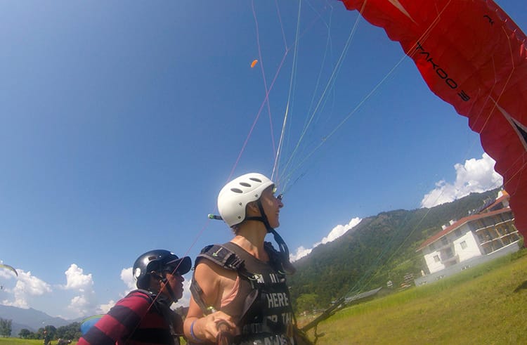 Michelle Della Giovanna from Full Time Explorer lands after paragliding in Nepal