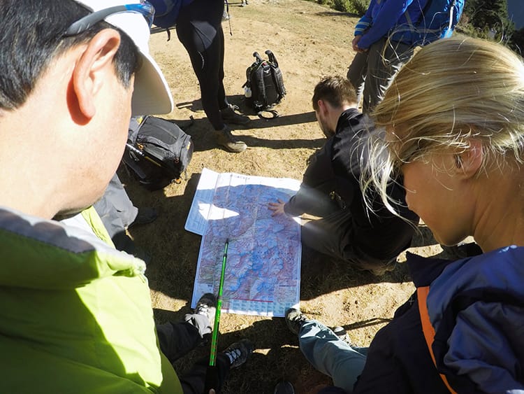 Trekkers and a guide map out the route to Everest Base Camp