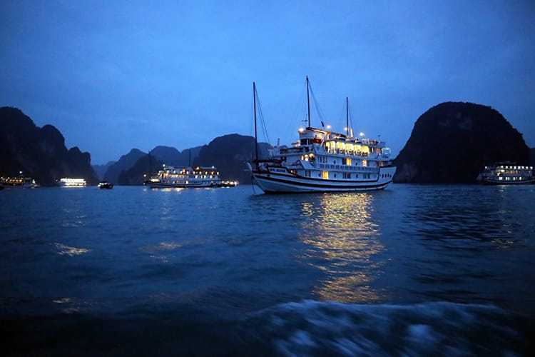 A boat floats at night in Halong Bay in Vietnam
