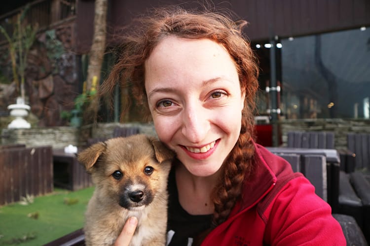 Michelle Della Giovanna from Full Time Explorer holds a tiny puppy at Green Valley Resort