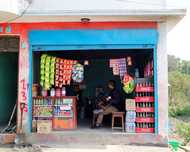 A small brightly painted shop in Tokha selling snacks