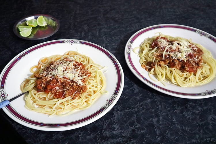 Two plates of spaghetti bolognese