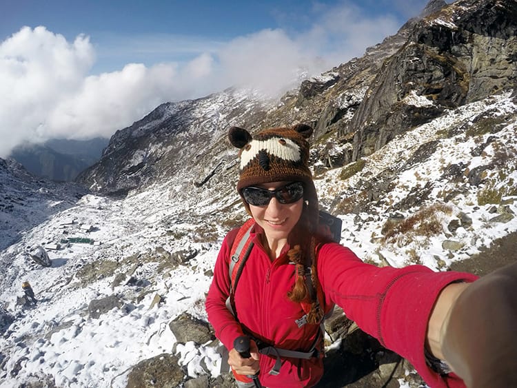 Michelle Della Giovanna from Full Time Explorer stops to pose for a selfie after surviving the worst part of the pass on the way back to Lukla