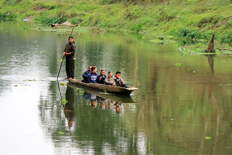 Michelle Della Giovanna from Full Time Explorer and family take a canoe ride down the river in Chitwan National Park