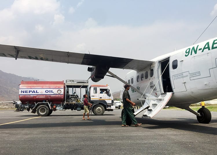 A small plane receiving more fuel before takeoff in Nepal