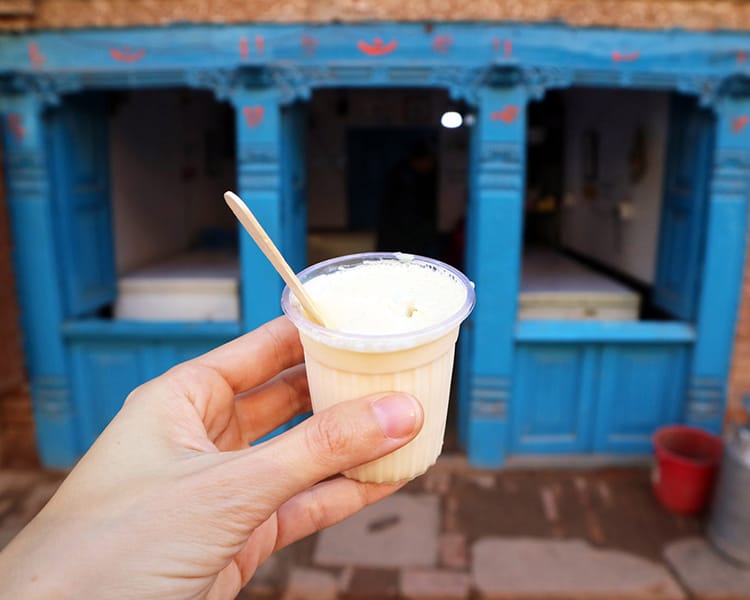 King curd yogurt in front of one of the traditional blue storefronts in Bhaktapur