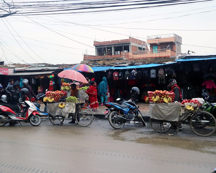 People shop from a street vendor at Kumal-Vinayak Khulla Bazar