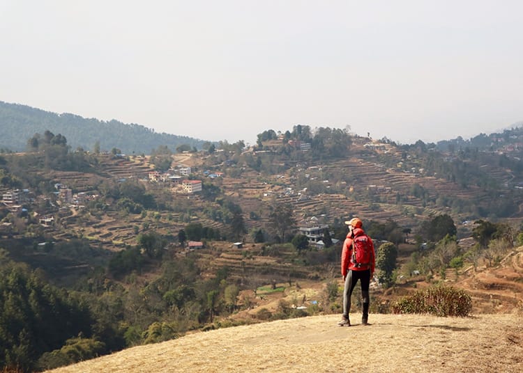 Michelle Della Giovanna from Full Time Explorer stands in front of the rolling hills along the Kathmandu Valley Trek, one of the Best Nepalese Trekking Routes for Beginners
