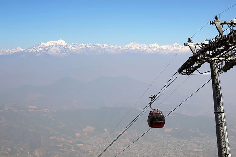 A cable car goes to Chandragiri with a clear view of the Himalaya behind it