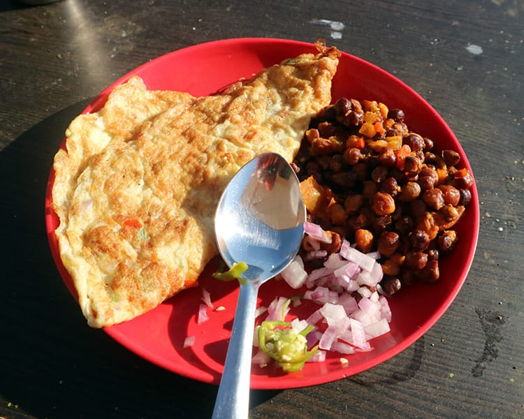 Breakfast omlette with curried chickpeas and onion on the side