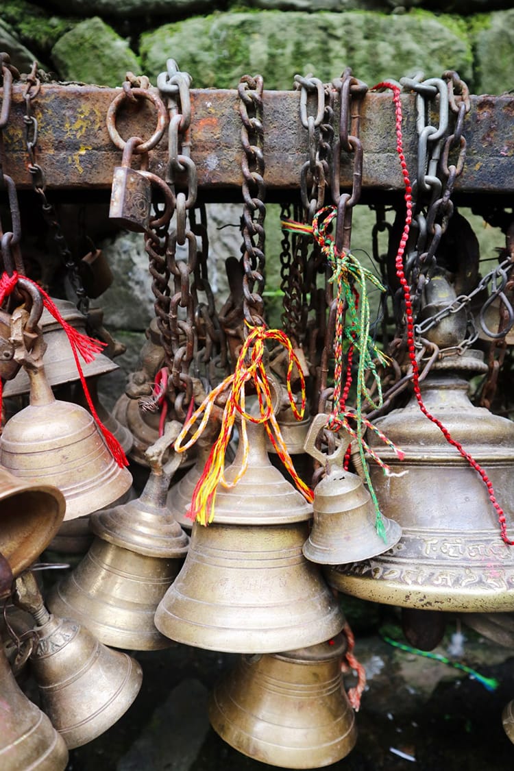 Numerous bells hanging stacked on top of each other at Dakshinkali Temple in Pharping