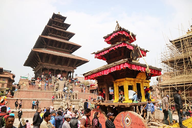 Nepali people line up in front of Nyatapola Temple in Bhaktapur to play tug of war with the chariot for Bisket Jatra