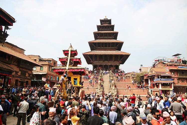 Nepali people line up in front of Nyatapola Temple in Bhaktapur to play tug of war with the chariot for Bisket Jatra