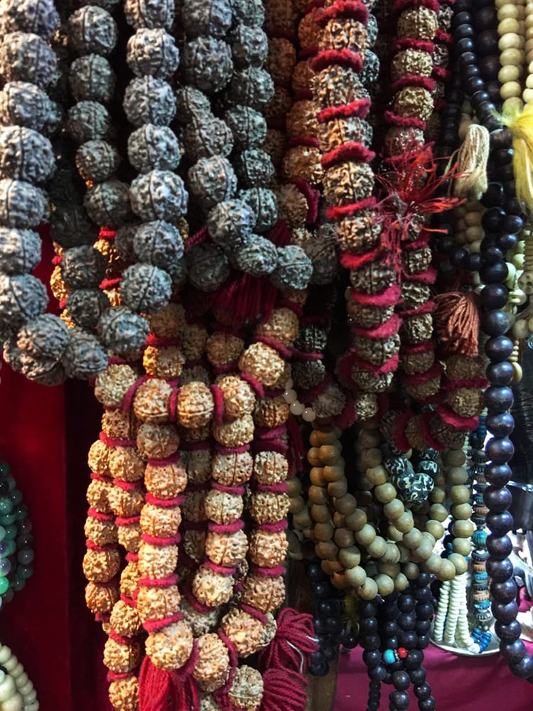 Mala beads hang on a display for sale in a souvenir shop in Kathmandu