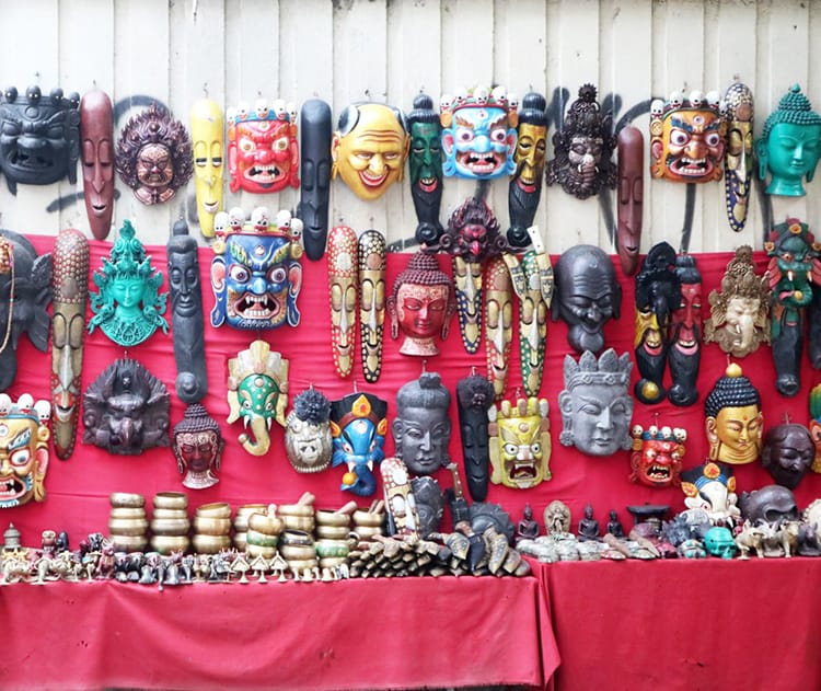 Brightly painted wood masks line the streets of Thamel to sell to tourists