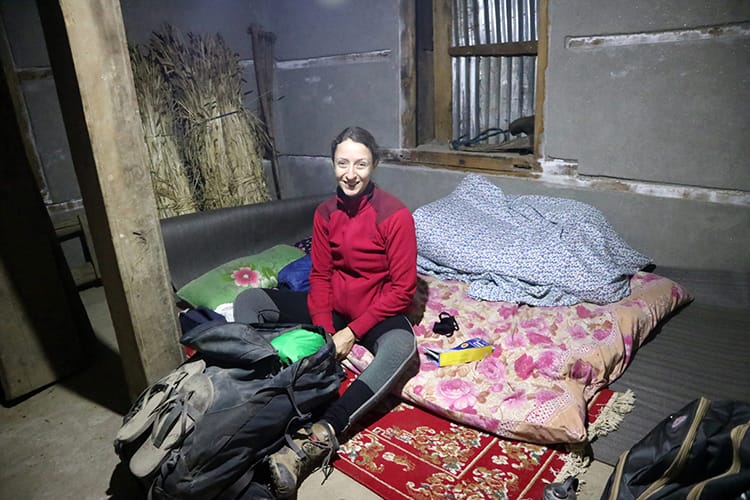 Michelle Della Giovanna from Full Time Explorer prepares to sleep on the storage room floor in a tea shop