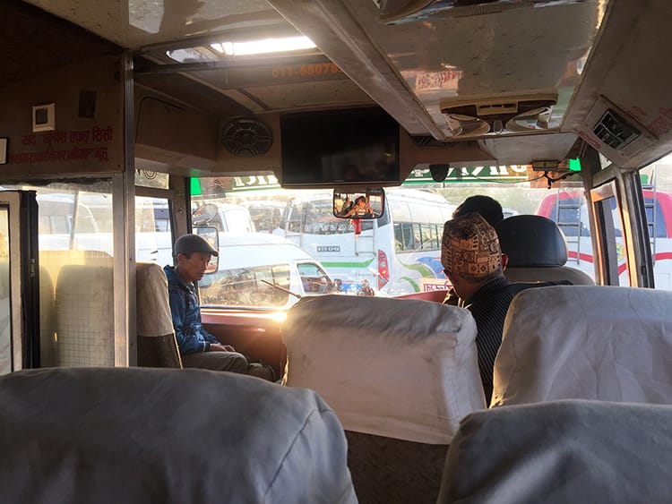 People board a local bus in Kathmandu early in the morning