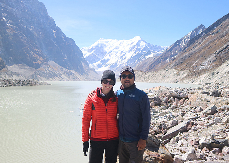 Michelle Della Giovanna from Full Time Explorer and Suraj Pradhan in front of Tsho Rolpa Lake