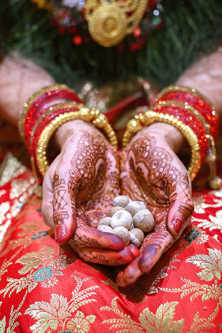 A bride holds betel nuts during a supari ceremony