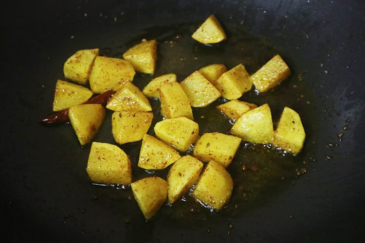 The potatoes frying in the spices