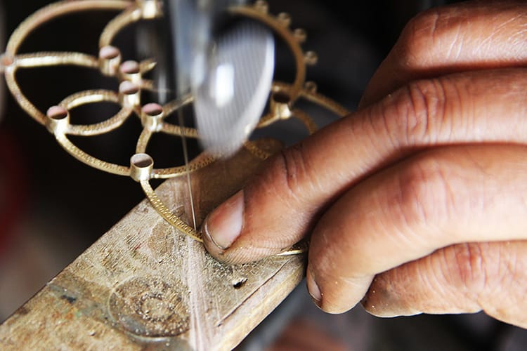 A man crafts a piece of jewelry