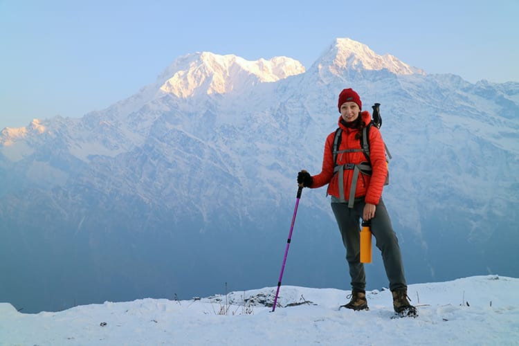 Michelle Della Giovanna from Full Time Explorer stands in front of the Annapurna Range along the Mardi Himal Base Camp Trek