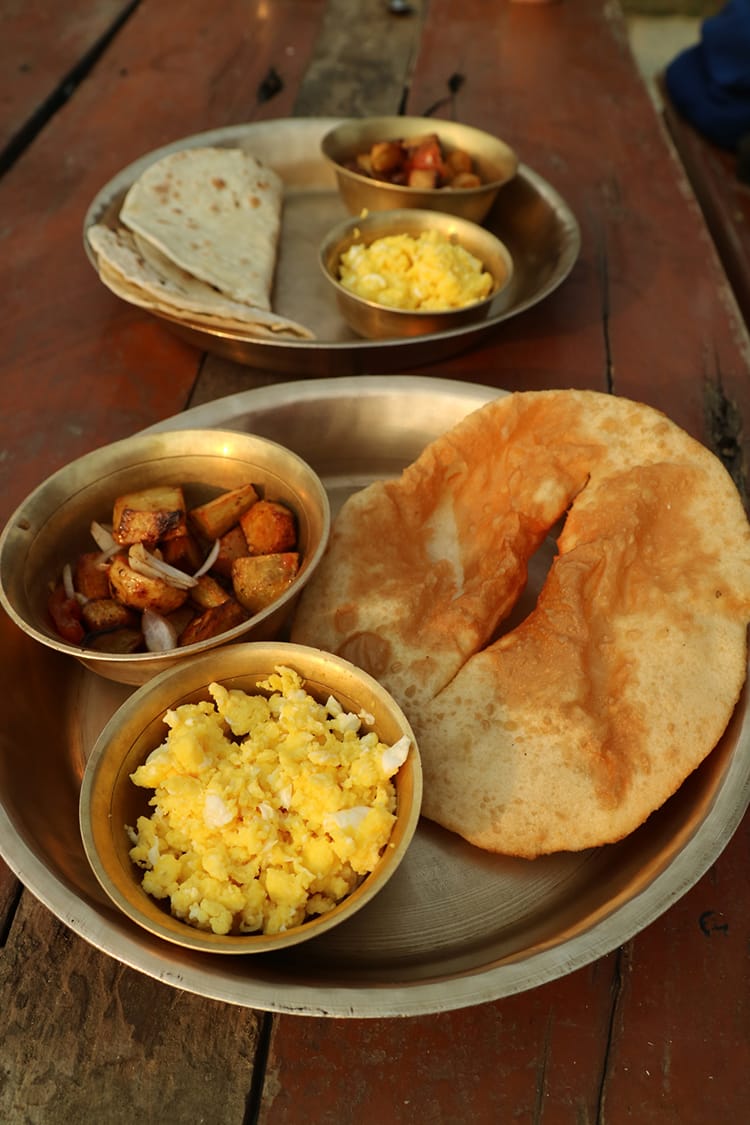 A simple breakfast including Tibetan bread, scrambled eggs, and breakfast potatoes