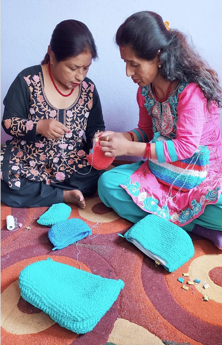 Two woman hand make purses for Samsara Creation