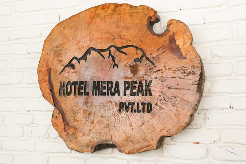 A wood sign in the entryway of Hotel Mera Peak