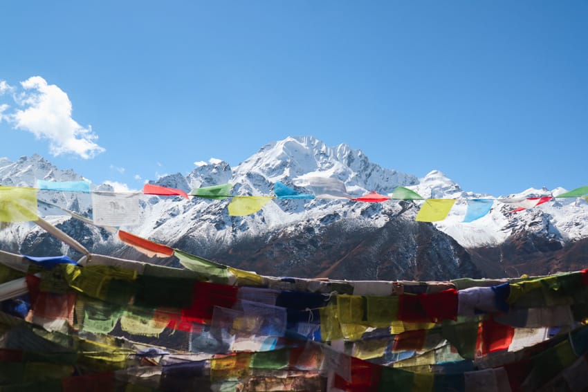 Prayer flags fly in front of the Langtang mountain range