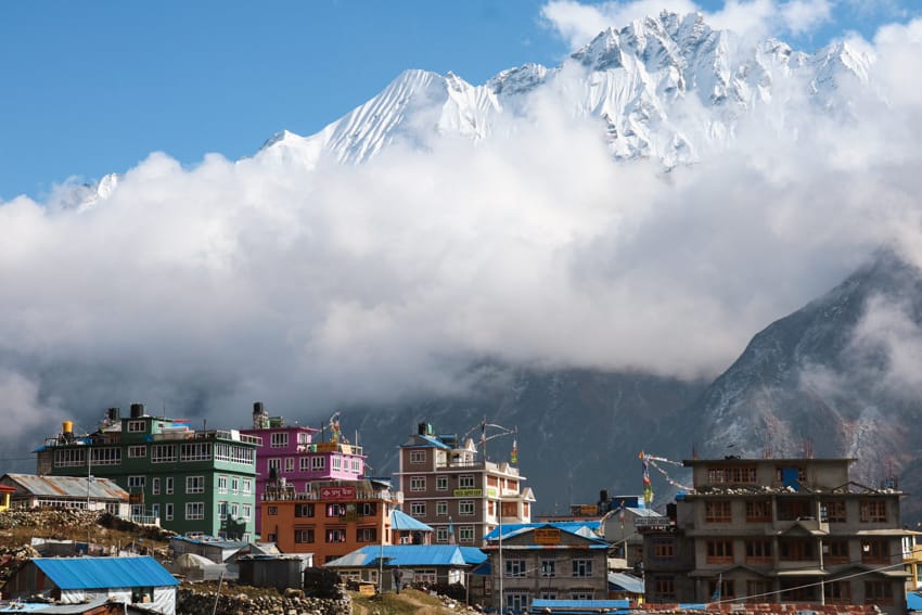 The himalaya mountains tower over the village of Kyanjin Gompa