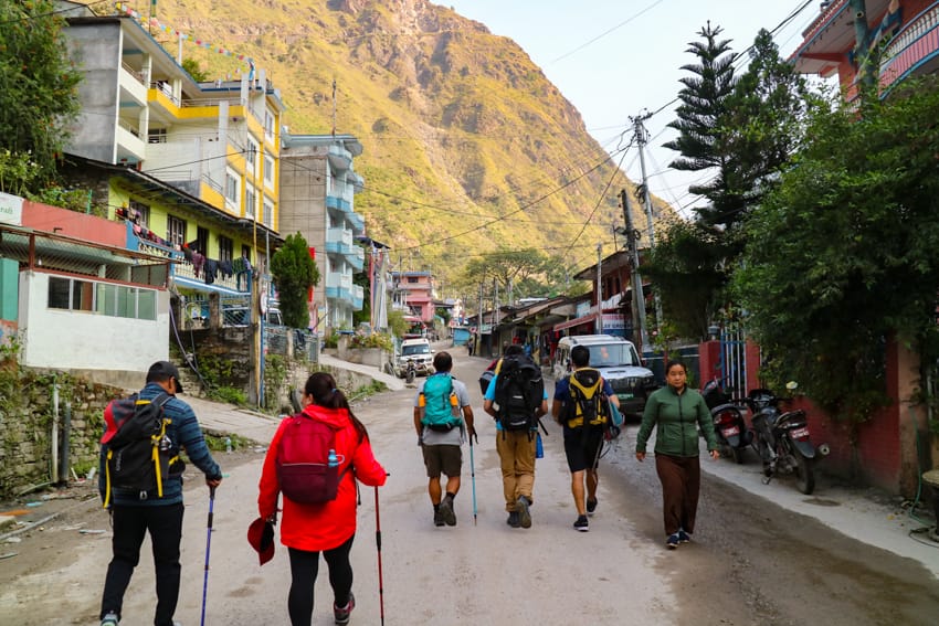 Trekkers walk through Syabrubesi on their way to start the Langtang Trek