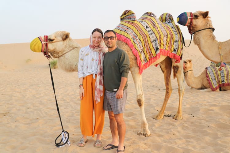 Michelle and Suraj with a camel during the overnight desert safari in Dubai