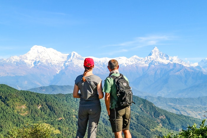 Michelle and Suraj stopping to look at the view of the Himalaya - Panchase Trek Packing List