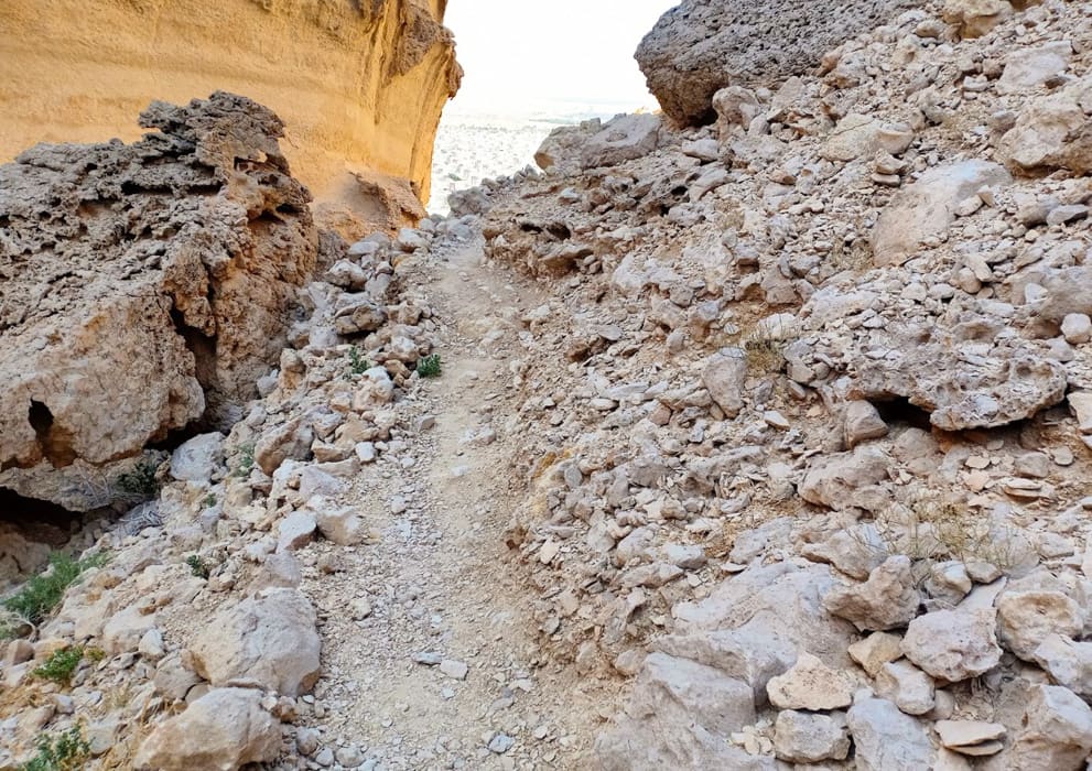 a trail going through rough terrain with rocks