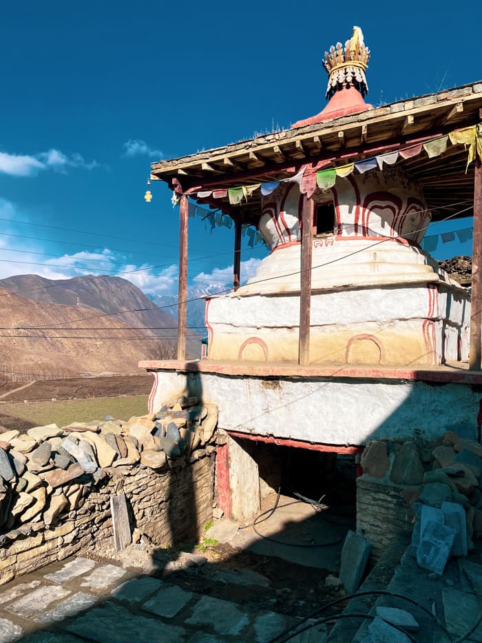 A Buddhist stupa in the middle of the village next to prayer wheels