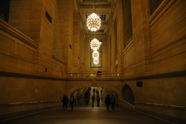 One of the large corridors in Grand Central Terminal with large circular chandeliers hanging