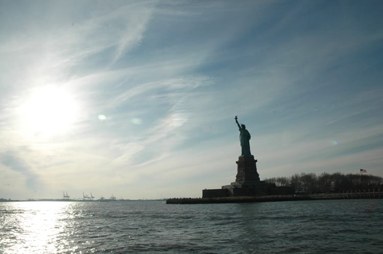 The statue of liberty as we approach on a boat