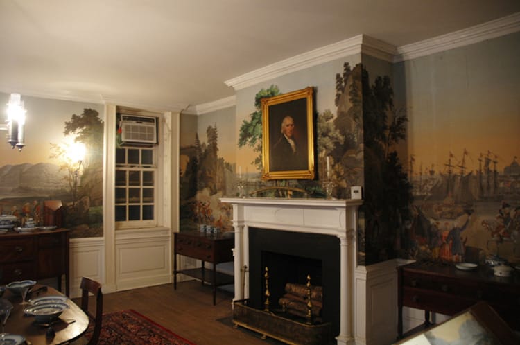 A room in Fraunces Tavern in NYC with a beautiful colonial mural painted on the wall