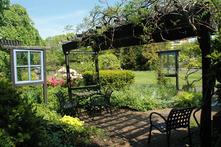 Flowers surround a sitting area in the Queens Botanical Garden in Flushing